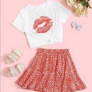 A cute kiss skirt and tee shirt out fit . Not used